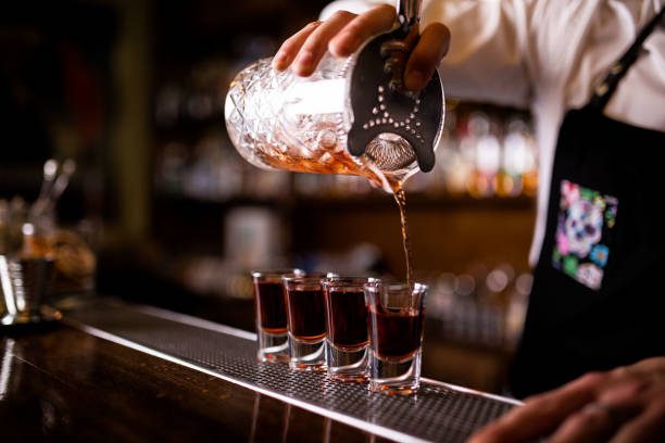 Bartender pouring the shots.